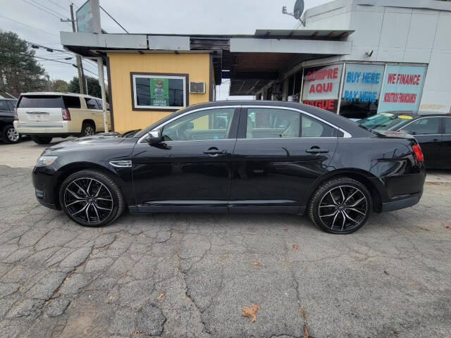 2013 Ford Taurus for sale at DAGO'S AUTO SALES LLC in Dalton, GA