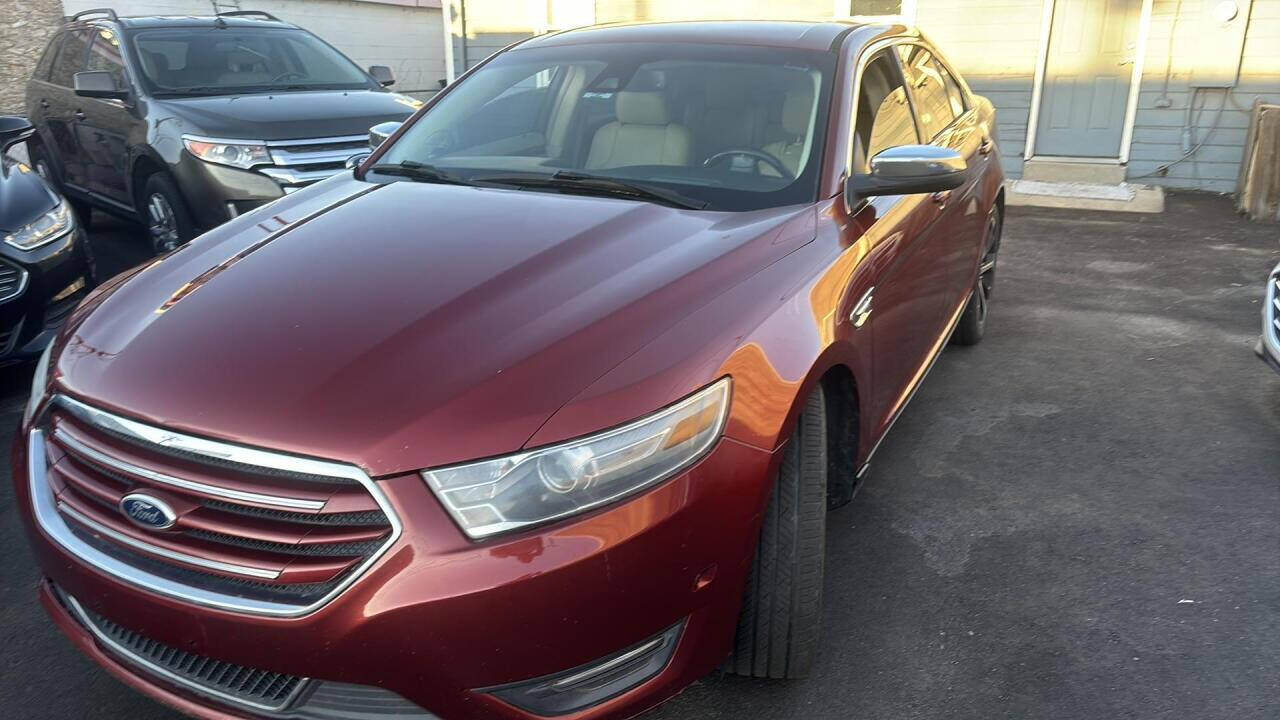 2014 Ford Taurus for sale at Ganda Auto Sales in Denver, CO