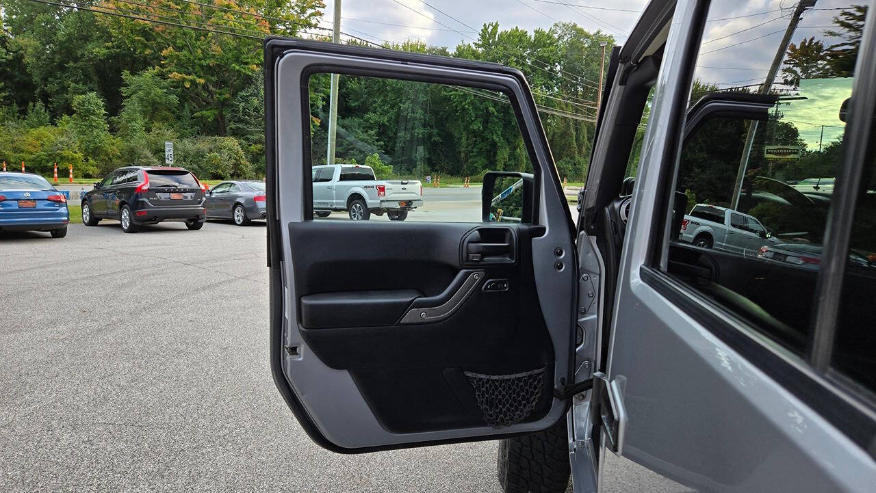 2014 Jeep Wrangler Unlimited for sale at North Ridge Auto Center LLC in Madison, OH