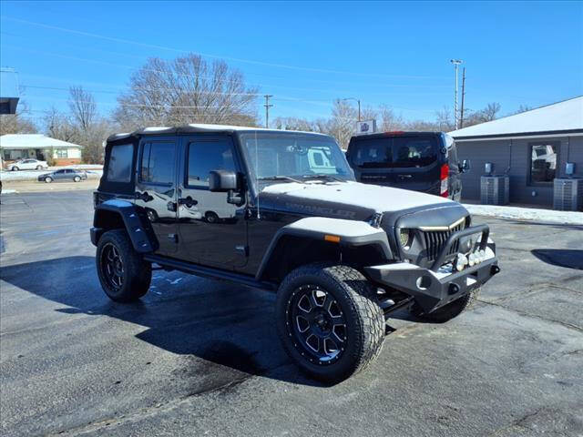 2016 Jeep Wrangler Unlimited for sale at HOWERTON'S AUTO SALES in Stillwater OK