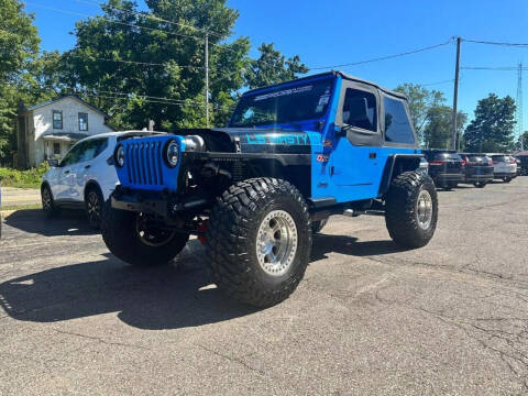 1997 Jeep Wrangler for sale at Rombaugh's Auto Sales in Battle Creek MI