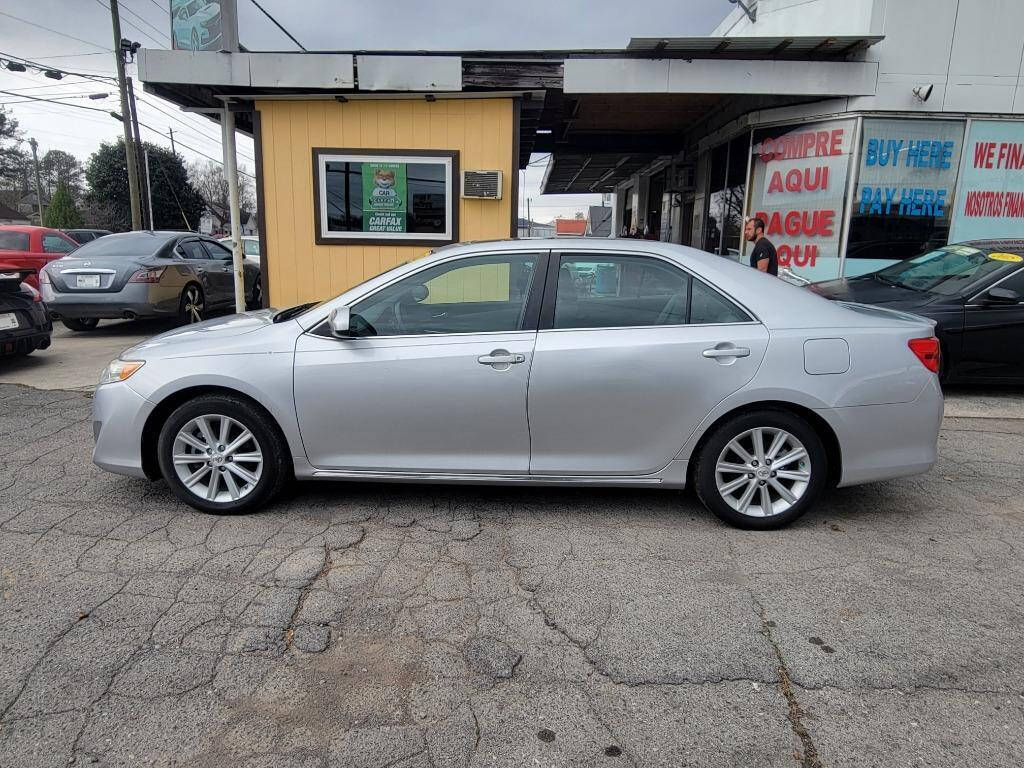 2012 Toyota Camry for sale at DAGO'S AUTO SALES LLC in Dalton, GA