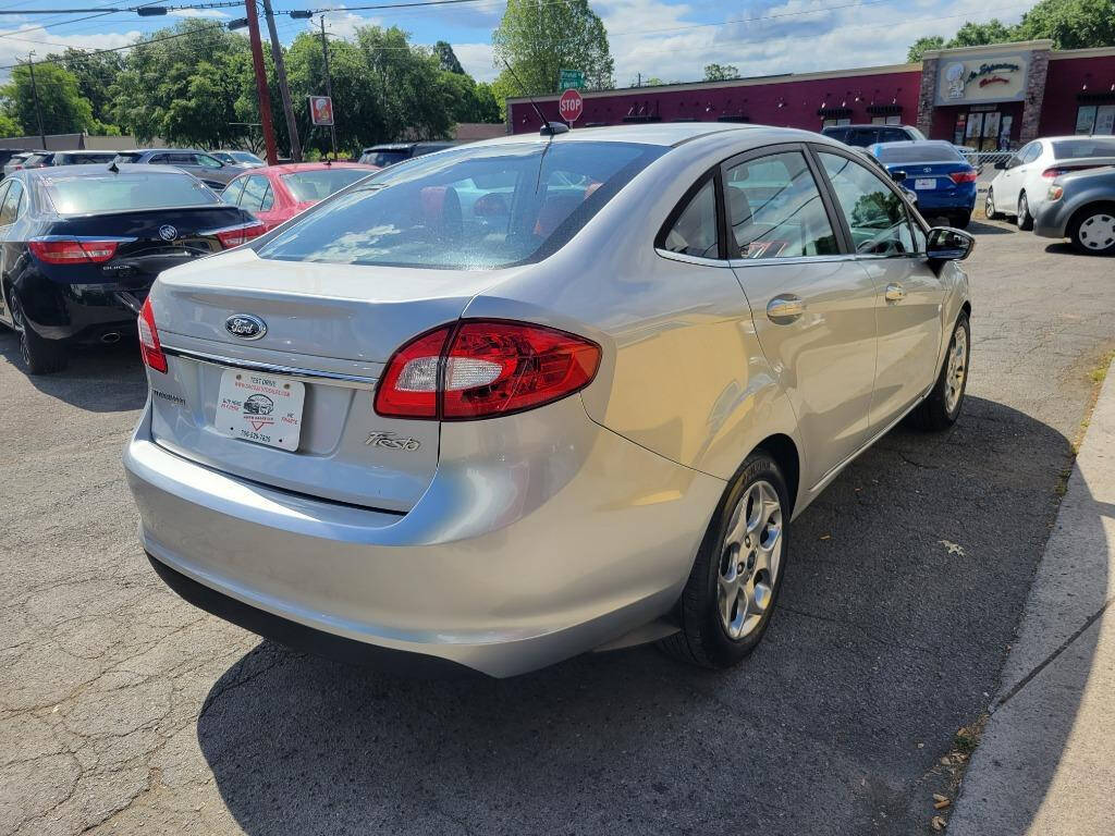 2013 Ford Fiesta for sale at DAGO'S AUTO SALES LLC in Dalton, GA