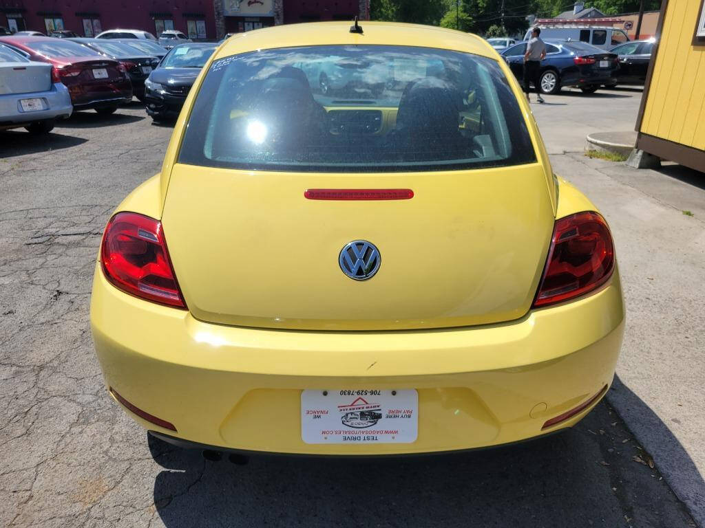 2012 Volkswagen Beetle for sale at DAGO'S AUTO SALES LLC in Dalton, GA