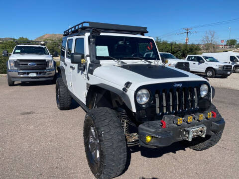 2014 Jeep Wrangler Unlimited for sale at BERKENKOTTER MOTORS in Brighton CO