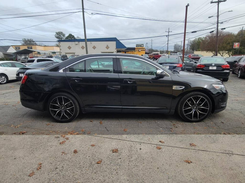 2013 Ford Taurus for sale at DAGO'S AUTO SALES LLC in Dalton, GA