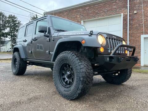 2014 Jeep Wrangler Unlimited for sale at Jim's Hometown Auto Sales LLC in Byesville OH