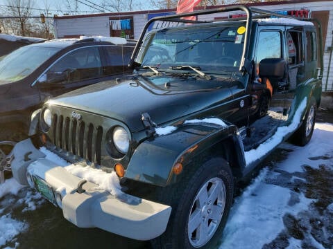 2011 Jeep Wrangler Unlimited for sale at Howe's Auto Sales in Lowell MA