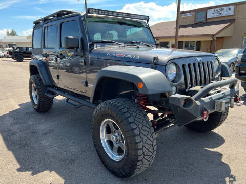 2014 Jeep Wrangler Unlimited for sale at BERKENKOTTER MOTORS in Brighton CO