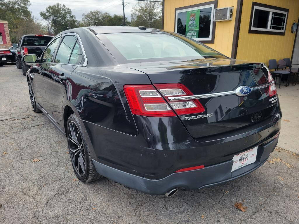 2013 Ford Taurus for sale at DAGO'S AUTO SALES LLC in Dalton, GA