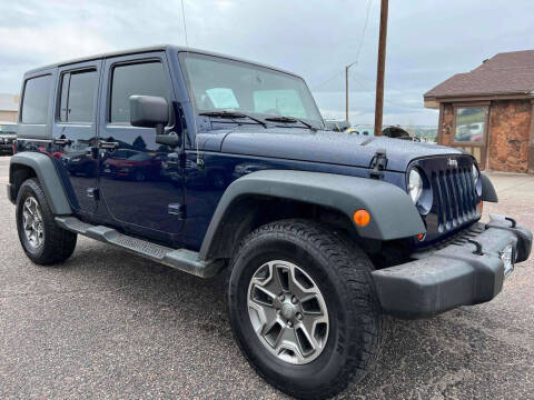 2013 Jeep Wrangler Unlimited for sale at BERKENKOTTER MOTORS in Brighton CO