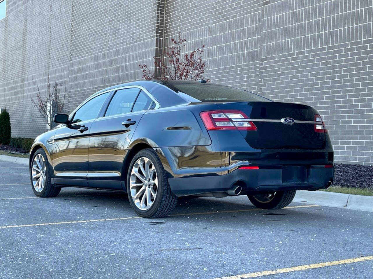 2014 Ford Taurus for sale at Phoenix Motor Co in Romulus, MI