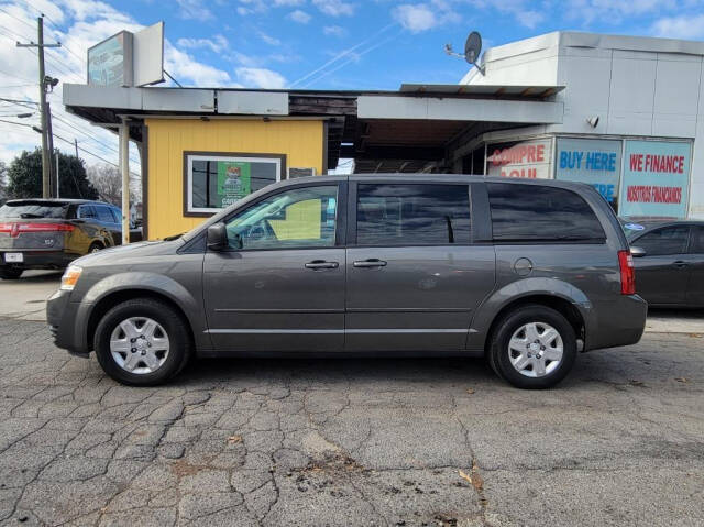 2010 Dodge Grand Caravan for sale at DAGO'S AUTO SALES LLC in Dalton, GA