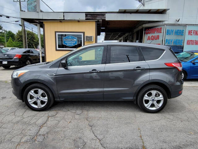 2015 Ford Escape for sale at DAGO'S AUTO SALES LLC in Dalton, GA