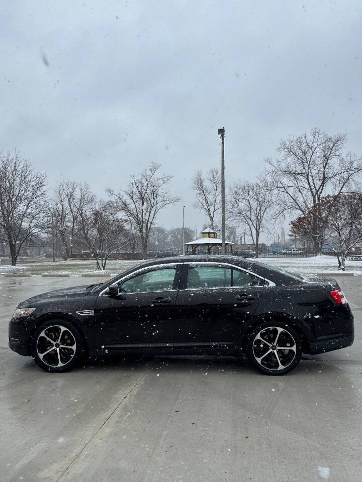 2014 Ford Taurus for sale at H & H AUTO GROUP in Detroit, MI