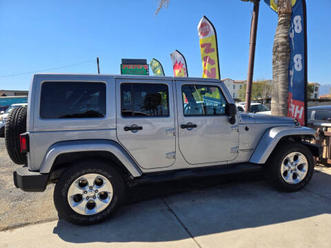 2014 Jeep Wrangler Unlimited for sale at E and M Auto Sales in Bloomington CA
