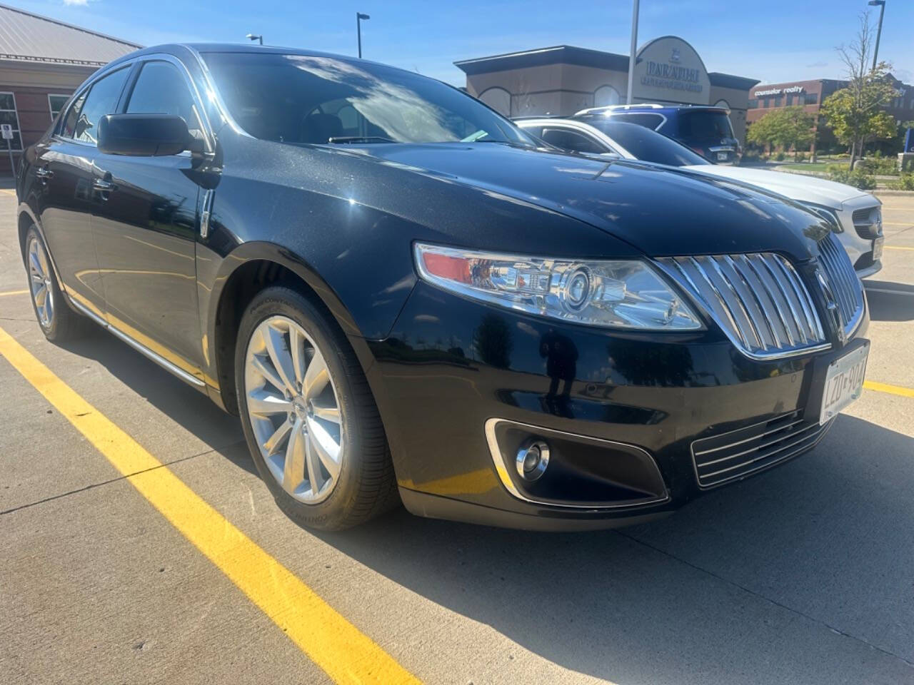 2011 Lincoln MKS for sale at JUST AUTOS in MINNEAPOLIS, MN