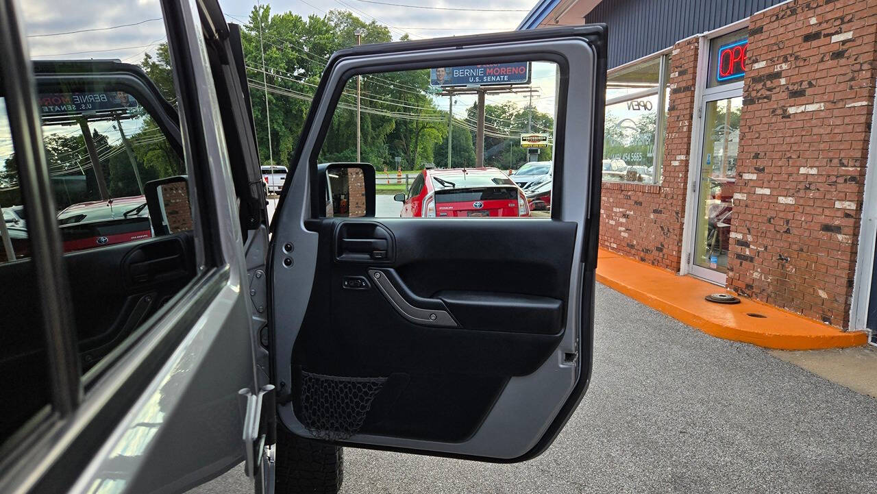 2014 Jeep Wrangler Unlimited for sale at North Ridge Auto Center LLC in Madison, OH