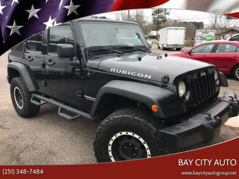 2009 Jeep Wrangler Unlimited for sale at Bay City Auto's in Mobile AL