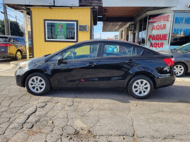 2015 Kia Rio for sale at DAGO'S AUTO SALES LLC in Dalton, GA