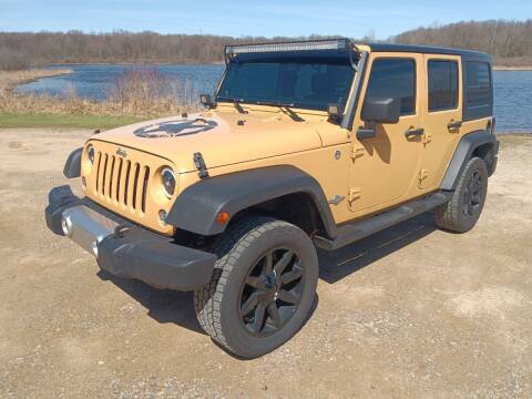 2014 Jeep Wrangler Unlimited for sale at Rombaugh's Auto Sales in Battle Creek MI