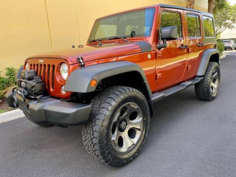 2014 Jeep Wrangler Unlimited for sale at DENMARK AUTO BROKERS in Riviera Beach FL