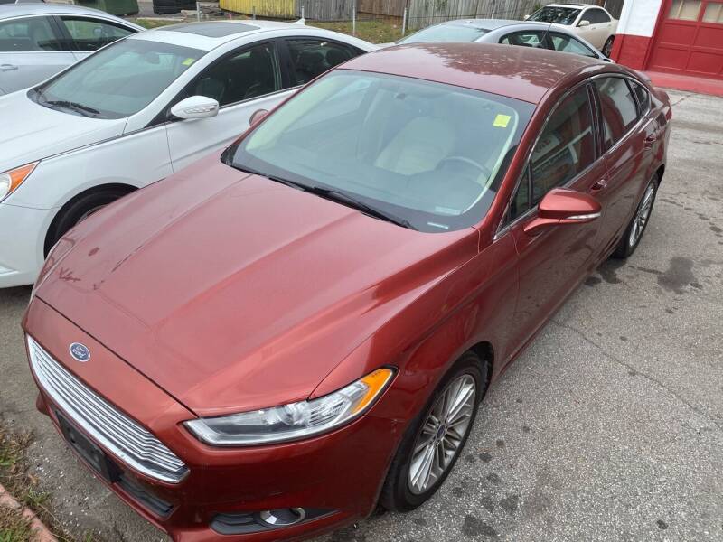 2014 Ford Fusion for sale at THE CAR MANN in Stone Mountain GA