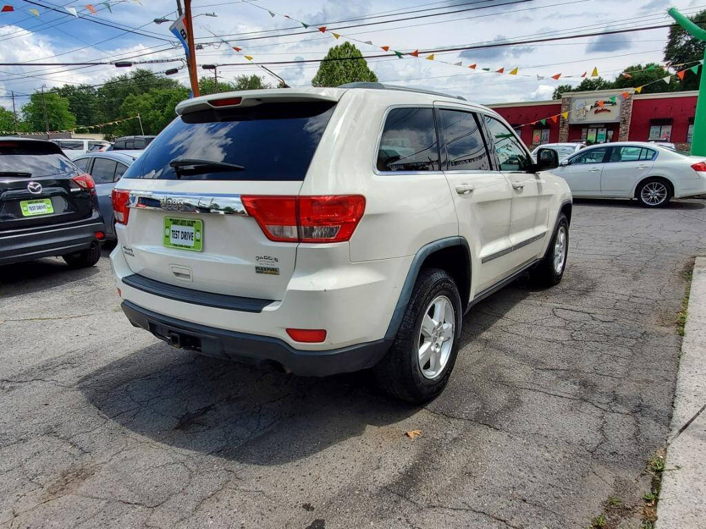 2011 Jeep Grand Cherokee for sale at DAGO'S AUTO SALES LLC in Dalton, GA